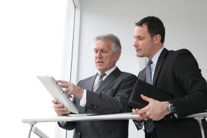 Sales people working on electronic tablet