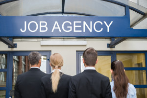 Businesspeople Standing Outside Employment Agency