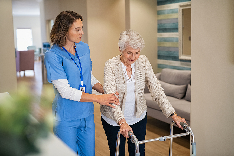 bigstock-Lovely-nurse-helping-old-woman-426080825